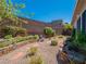 Inviting backyard featuring desert landscaping, retaining walls, and rock at 816 Stannard Ct, Henderson, NV 89052