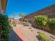 Secluded backyard featuring desert landscaping, gravel, plantings, and a bench at 816 Stannard Ct, Henderson, NV 89052