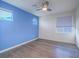 Bedroom with wood floors, a ceiling fan, and a light blue accent wall at 816 Stannard Ct, Henderson, NV 89052
