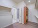 Large walk-in closet with wood floors and open door leading to bathroom at 816 Stannard Ct, Henderson, NV 89052