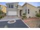 Contemporary two-story home boasts a two-car garage, desert landscaping, and neutral exterior paint at 816 Stannard Ct, Henderson, NV 89052