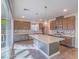 Modern kitchen with large granite island, stainless steel appliances, wood flooring, and abundant natural light at 816 Stannard Ct, Henderson, NV 89052