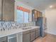 Kitchen with stainless steel appliances, stylish backsplash, wooden cabinets, and double bowl sink at 816 Stannard Ct, Henderson, NV 89052