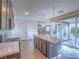 Open kitchen layout with central island, stainless steel appliances, and view to the living area at 816 Stannard Ct, Henderson, NV 89052