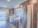 Modern kitchen featuring stainless steel refrigerator, tiled backsplash, ample counter space and cabinetry at 816 Stannard Ct, Henderson, NV 89052