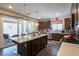 Well-lit kitchen featuring a central island, stainless steel appliances, and sliding glass doors to the patio at 816 Stannard Ct, Henderson, NV 89052