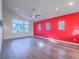 Bright, open living area with hardwood floors, ceiling fan, and large windows at 816 Stannard Ct, Henderson, NV 89052