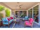 Relaxing covered patio with comfortable seating, ceiling fan, and sliding glass doors at 816 Stannard Ct, Henderson, NV 89052