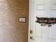 Close up of the front door featuring the house number and decorative welcome sign at 833 Aspen Peak Loop # 2613, Henderson, NV 89011