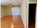 Open-concept living room with wood floors, neutral paint, and sliding glass door at 833 Aspen Peak Loop # 2613, Henderson, NV 89011