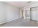 Neutral bedroom boasting carpet, closet with mirrored doors, and access to other rooms at 8600 W Charleston Blvd # 1043, Las Vegas, NV 89117