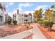 Attractive condo with red trim, balconies, desert landscaping, and a charming walkway at 8600 W Charleston Blvd # 1043, Las Vegas, NV 89117