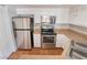 Kitchen featuring stainless steel appliances, white cabinets, and wood flooring at 8600 W Charleston Blvd # 1043, Las Vegas, NV 89117