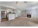 Open living room featuring a fireplace, and a kitchen with stainless steel appliances at 8600 W Charleston Blvd # 1043, Las Vegas, NV 89117