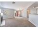 Bright living room featuring a fireplace, neutral carpet, and a sliding door leading to the outside at 8600 W Charleston Blvd # 1043, Las Vegas, NV 89117