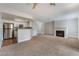 Open living room featuring a fireplace, and a kitchen with stainless steel appliances at 8600 W Charleston Blvd # 1043, Las Vegas, NV 89117