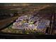 Night aerial view of a commercial property including retail and restaurants amid city lights and distant mountains at 8777 W Maule Ave # 3090, Las Vegas, NV 89148