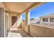 View of private balcony with door, stucco walls, and neighborhood views on a bright, sunny day at 8777 W Maule Ave # 3090, Las Vegas, NV 89148