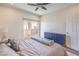 Bright bedroom with a ceiling fan, large slider to the balcony, and a stylish blue cabinet at 8777 W Maule Ave # 3090, Las Vegas, NV 89148