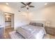 Bright bedroom featuring a ceiling fan, carpet, and a glimpse into an en-suite bathroom at 8777 W Maule Ave # 3090, Las Vegas, NV 89148