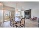 Open concept living space featuring a dining area with a large table and access to an outdoor balcony at 8777 W Maule Ave # 3090, Las Vegas, NV 89148