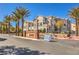 View of the Esplanade community entrance, enhanced by mature palms and desert landscaping at 8777 W Maule Ave # 3090, Las Vegas, NV 89148