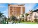 Commercial property with golden facade and lush landscaping under a clear sky at 8777 W Maule Ave # 3090, Las Vegas, NV 89148