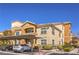 Well-kept apartment complex features covered parking, lush greenery, and desert landscaping at 8777 W Maule Ave # 3090, Las Vegas, NV 89148