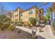 Exterior shot of a three-story building displaying manicured landscaping and a view of the upper level patios at 8777 W Maule Ave # 3090, Las Vegas, NV 89148