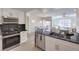 Modern kitchen with stainless steel appliances, sleek countertops, and open layout to the dining and living areas at 8777 W Maule Ave # 3090, Las Vegas, NV 89148