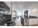 Modern kitchen with black and white finishes that flow into an open concept living and dining area at 8777 W Maule Ave # 3090, Las Vegas, NV 89148