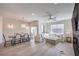 Open-concept living room with a dining area and modern decor, bathed in natural light from large windows at 8777 W Maule Ave # 3090, Las Vegas, NV 89148