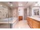 Beautiful bathroom featuring double vanities, a soaking tub and an elegant, glass enclosed shower with custom tile at 9101 Alta Dr # 307, Las Vegas, NV 89145