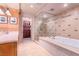 Luxurious bathroom featuring a soaking tub, glass enclosed shower with decorative tile work, and custom cabinets at 9101 Alta Dr # 307, Las Vegas, NV 89145