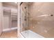 Tiled shower with glass door and separate shelving unit at 9101 Alta Dr # 307, Las Vegas, NV 89145