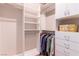 Spacious walk-in closet with custom shelving, cabinets, and hanging rods for organized storage of clothes and accessories at 9101 Alta Dr # 307, Las Vegas, NV 89145