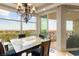 Inviting dining area with a chandelier and balcony access, framed by large windows offering scenic city views at 9101 Alta Dr # 307, Las Vegas, NV 89145