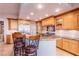 Gourmet kitchen featuring wood cabinetry, granite countertops, and stainless steel appliances at 9101 Alta Dr # 307, Las Vegas, NV 89145
