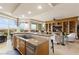 Open-concept kitchen featuring a large island with bar seating and a seamless flow into the dining area at 9101 Alta Dr # 307, Las Vegas, NV 89145