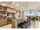 Well-appointed kitchen with bar-style seating, offering seamless transition to dining area and stunning city views at 9101 Alta Dr # 307, Las Vegas, NV 89145