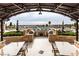 Outdoor kitchen and dining area with a grill and ample seating overlooking city views at 9101 Alta Dr # 307, Las Vegas, NV 89145