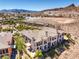Aerial view of a sprawling estate with a tile roof and beautiful landscaping at 10 Via Visione # 103, Henderson, NV 89011