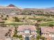 Aerial view of a luxury estate featuring a tile roof, desert landscaping, and golf course views at 10 Via Visione # 103, Henderson, NV 89011