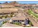 Aerial view of a beautiful home with a golf course and mountain views at 10 Via Visione # 103, Henderson, NV 89011