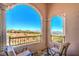 Arched balcony showcasing golf course, lake, and mountain views at 10 Via Visione # 103, Henderson, NV 89011
