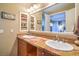Ensuite featuring double sinks, a large mirror, and updated fixtures at 10 Via Visione # 103, Henderson, NV 89011