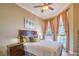 Comfortable bedroom with large windows, ceiling fan, and stylish decor for a cozy and inviting atmosphere at 10 Via Visione # 103, Henderson, NV 89011