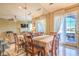 Bright dining room featuring a large table and chairs with a view of the outdoors at 10 Via Visione # 103, Henderson, NV 89011