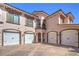 Charming townhome with four garages, desert landscaping, and a brick paved driveway at 10 Via Visione # 103, Henderson, NV 89011