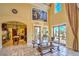 Welcoming foyer showcasing travertine flooring, elegant decor, and access to the kitchen at 10 Via Visione # 103, Henderson, NV 89011